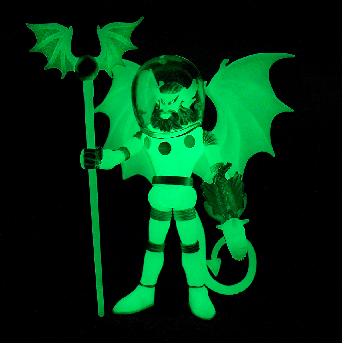 A MYSTRON COSMIC RADIATION glow in the dark figure holding a bat.