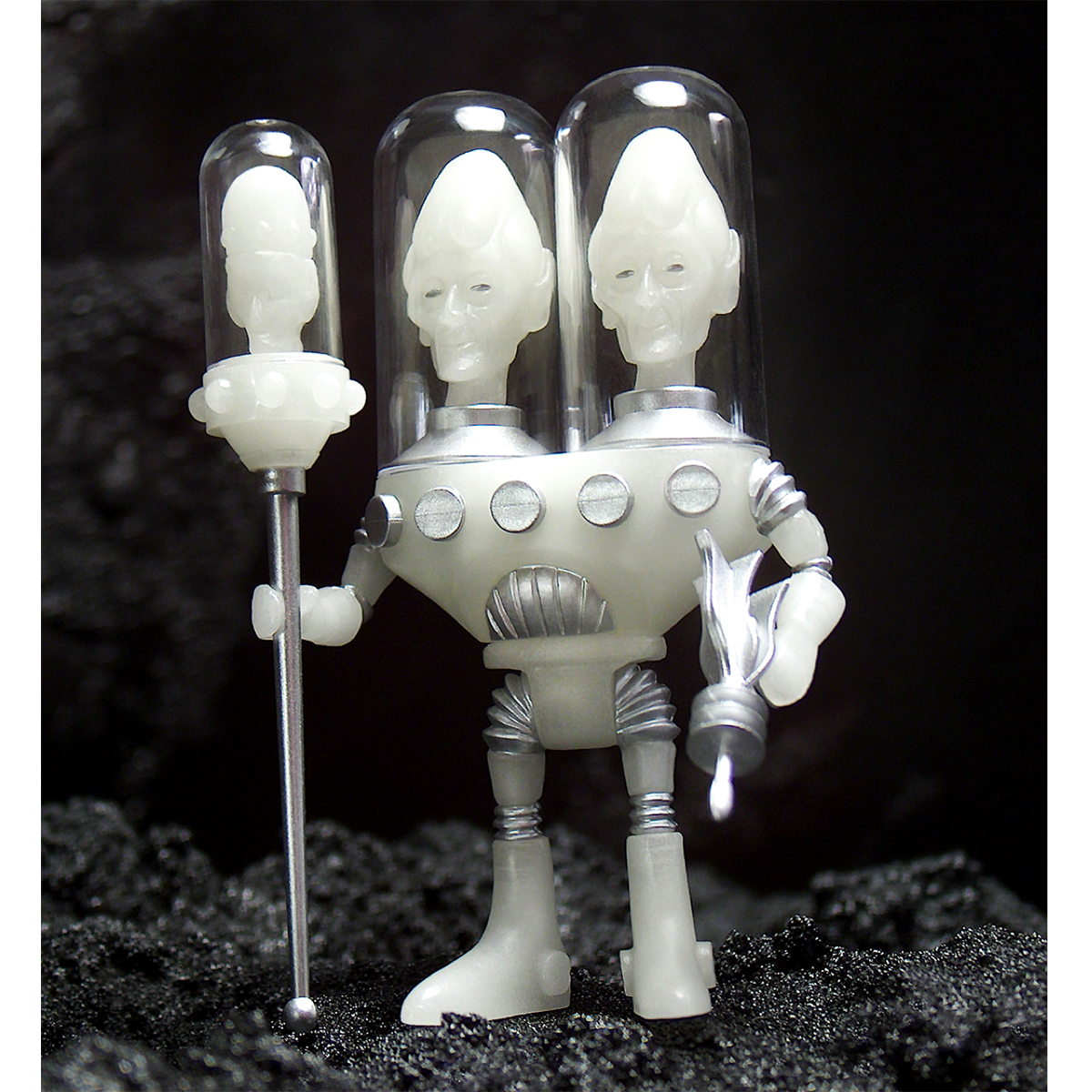 A Gemini Cosmic Radiation figure with a white head and two arms.
