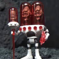 A red and white GEMIMI 2016 ULSTRIAX ONELL COSMIC CREATOR EXCLUSIVE LIMITED EDITION action figure holding a bottle of pills.