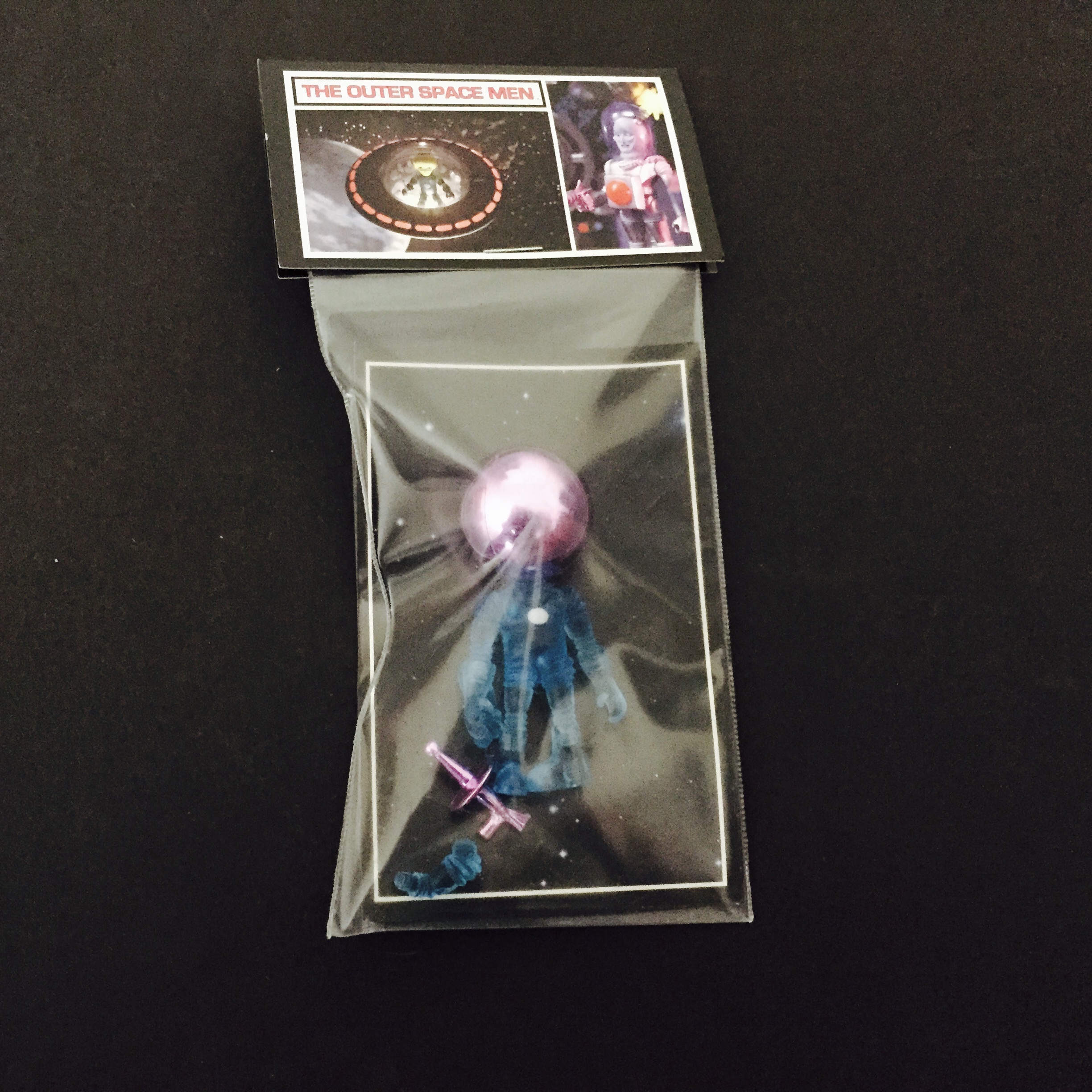 A 2011 GALACTIC HOLIDAY ALPHA 7 CLEAR BLUE WITH LAVENDER ACCESSORIES in a package.