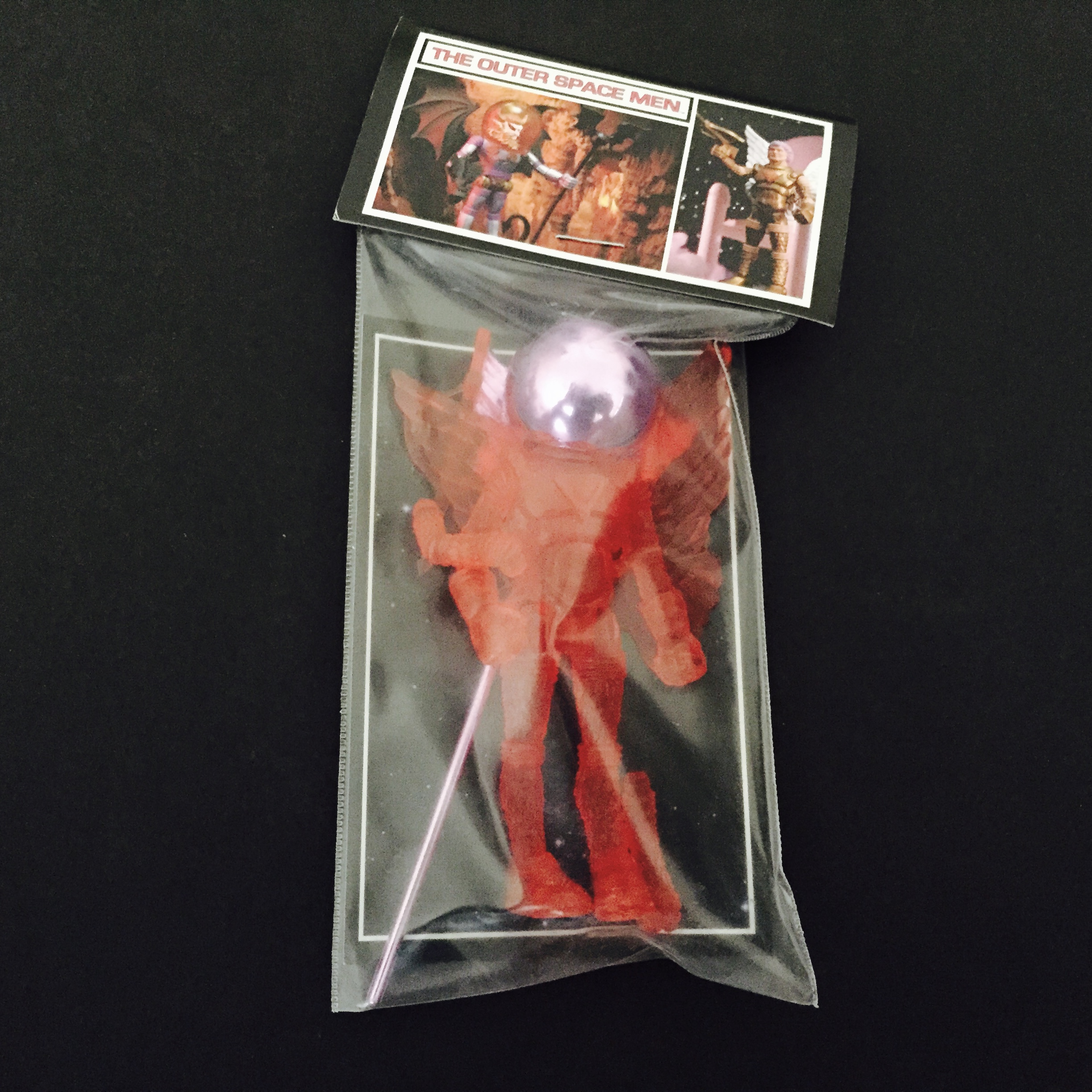 A 2011 GALACTIC HOLIDAY COMMANDER COMET LAVENDER ACC'S in a plastic bag with a red ball in it.