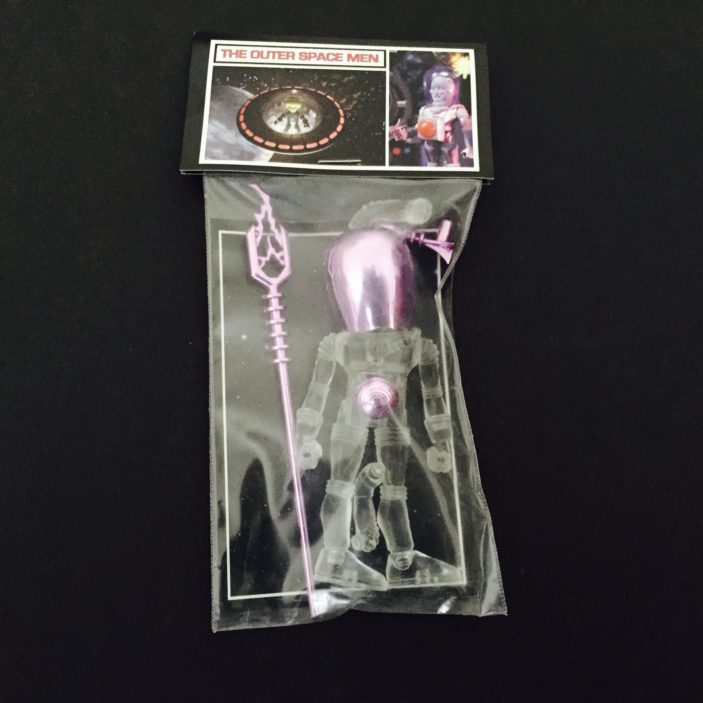A plastic 2011 GALACTIC HOLIDAY ELECTRON+ CLEAR WITH LAVENDER ACC'S toy in a package with a purple handle.