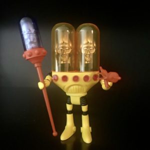 A yellow 2012 GEMINI INFINITY PAINTED 1968 VERSION LOOSE FIGURE holding a glass bottle.