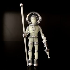 A figure in a space suit holding HORROSCOPE COSMIC RADIATION.