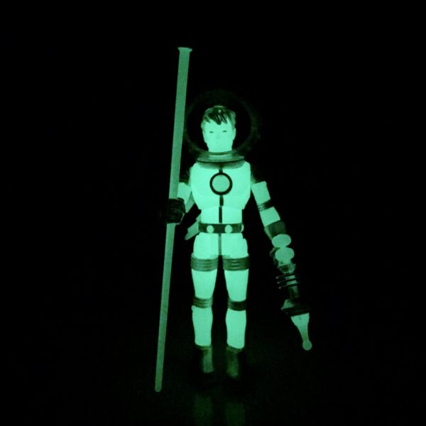 A JACK ASTEROID COSMIC RADIATION figure holding a stick.