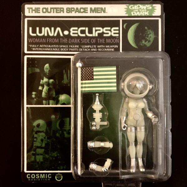A figure of a LUNA ECLIPSE COSMIC RADIATION L/E CARDED EDITION female astronaut in a package.