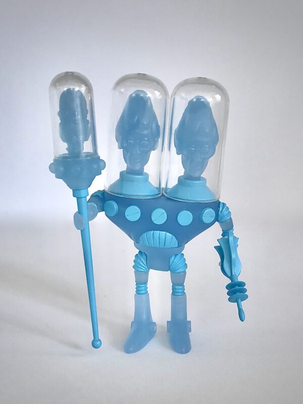 A blue toy figure holding a plastic syringe in the shape of 2020 CYCLOPS BLUESTAR EDITION.