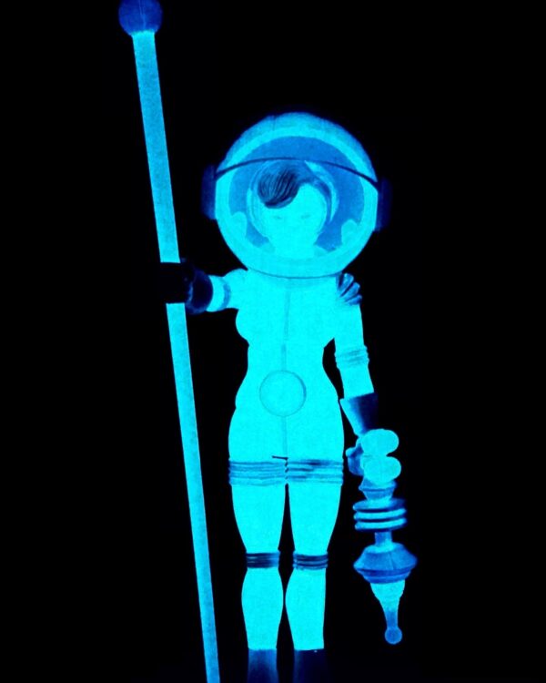 A 2023 TERRA FIRMA BLUESTAR figure glowing blue in the dark while holding a stick.